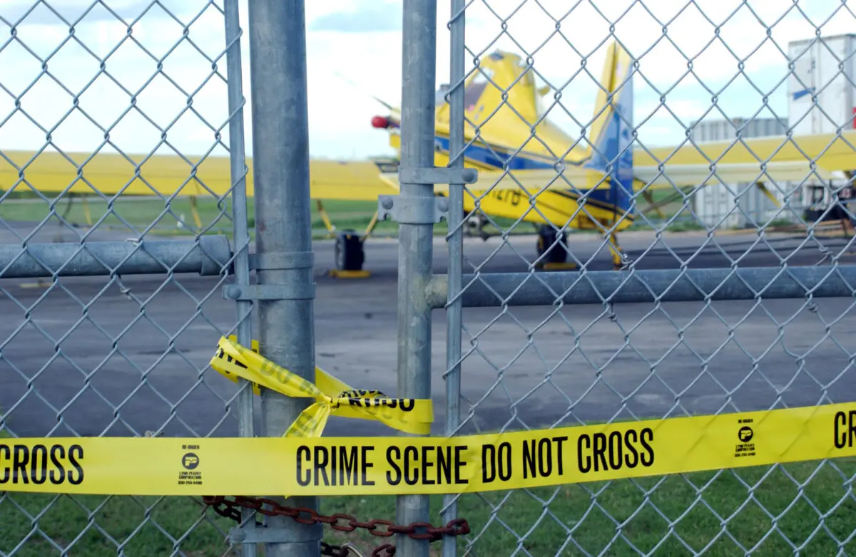 The crop-dusting airplane that suspected terrorist Mohamed Atta once allegedly tried to rent sits idle behind police tape on a Belle Glades, Fla. airfield, on Sept. 24, 2001. (Kelly Owen/Getty Images)