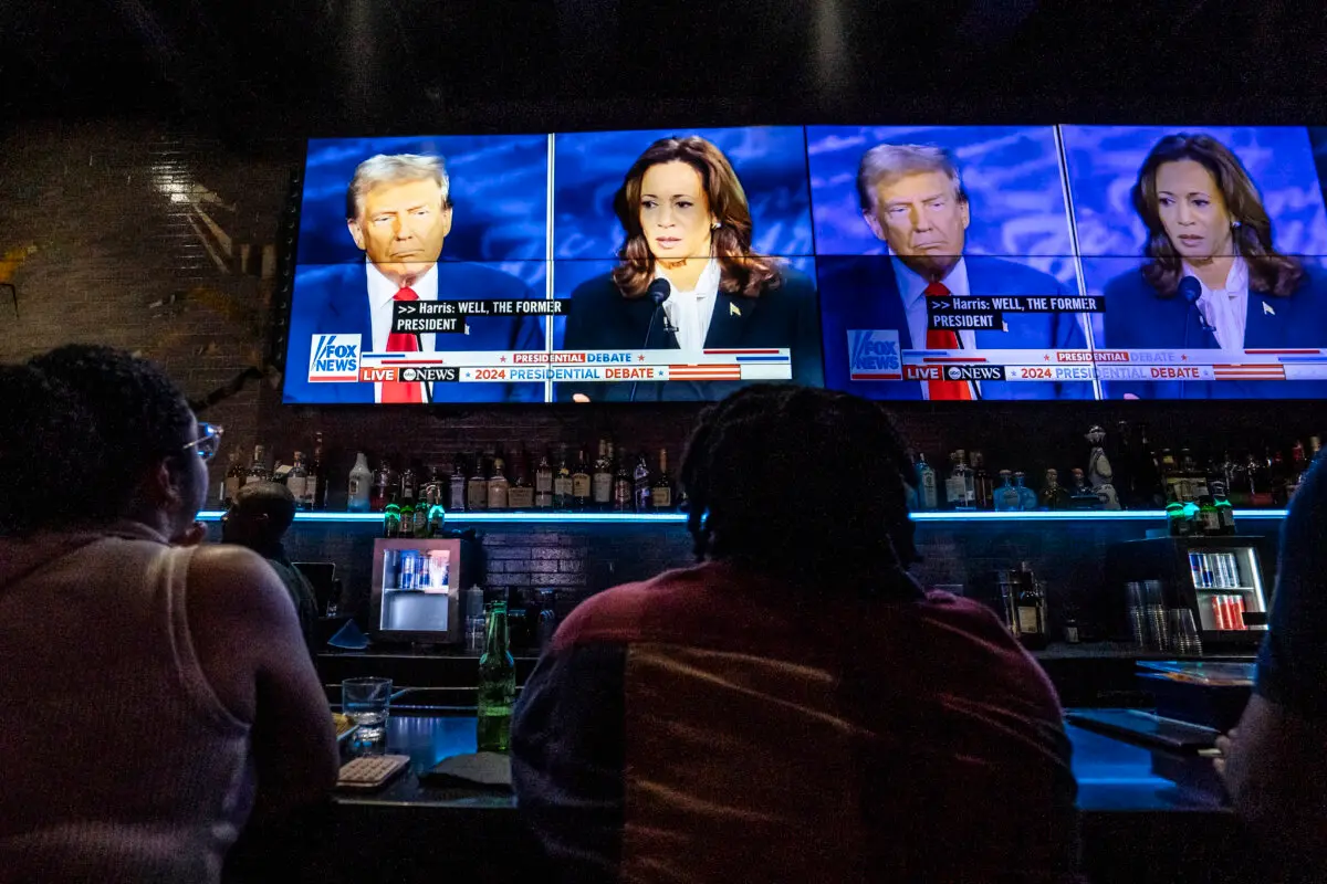 People watch the presidential debate between Democratic presidential nominee, Vice President Kamala Harris, and Republican presidential nominee, former President Donald Trump, at a watch party at the Slate bar and lounge in New York City on Sept. 10, 2024. (Samira Bouaou/The Epoch Times)