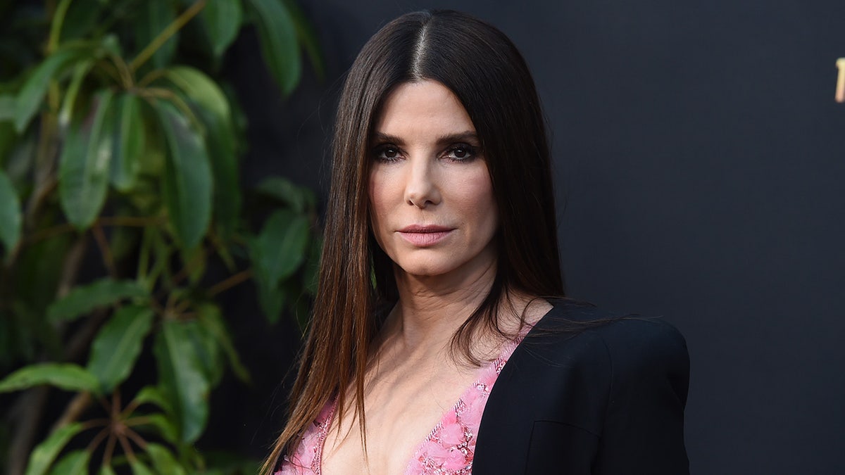 Sandra Bullock in a pink dress and black jacket at 