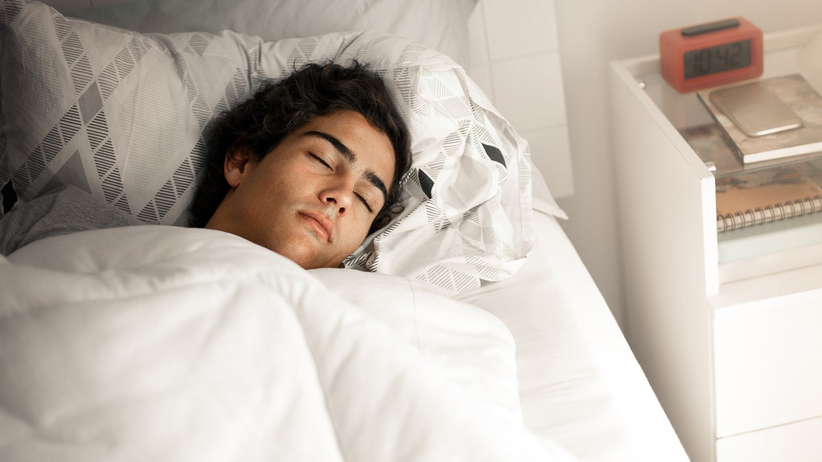 Teenager sleeping in bed