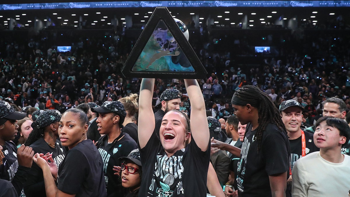 Sabrina Ionescu lifts WNBA Finals trophy