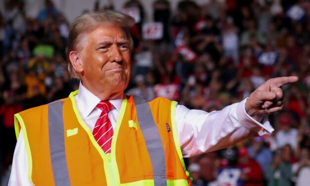 The Art of the Troll: Trump Wears Garbage Worker Vest to Wisconsin Rally