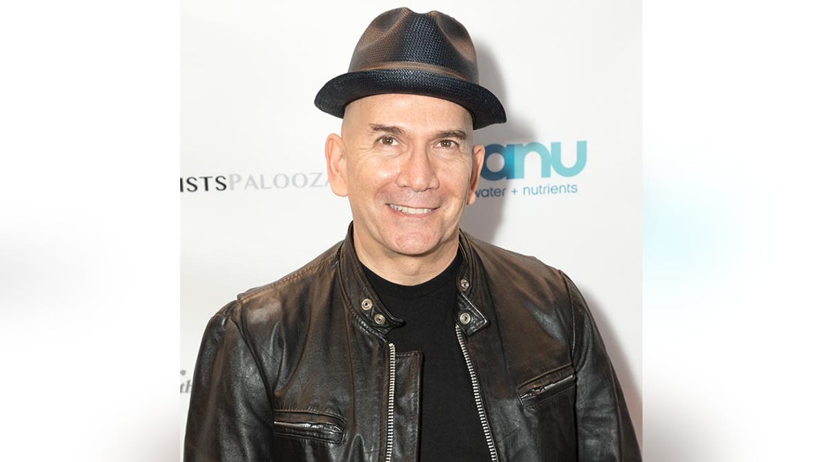 Jack Merrill in a black leather jacket and black hat