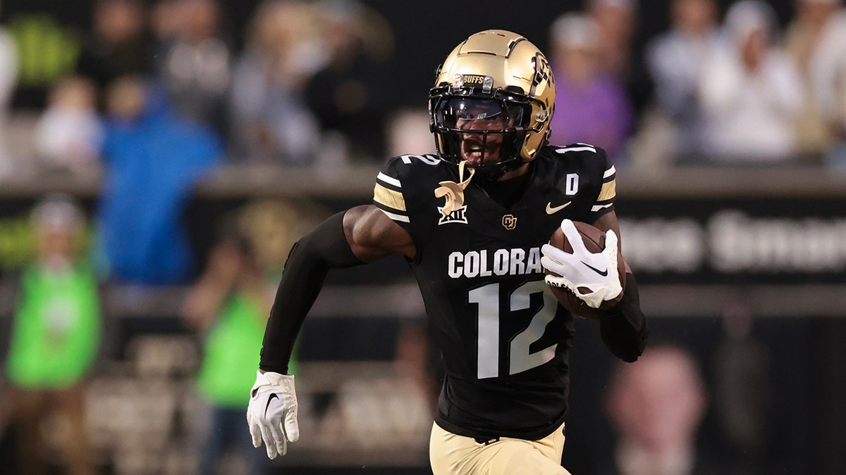 Travis Hunter running with ball