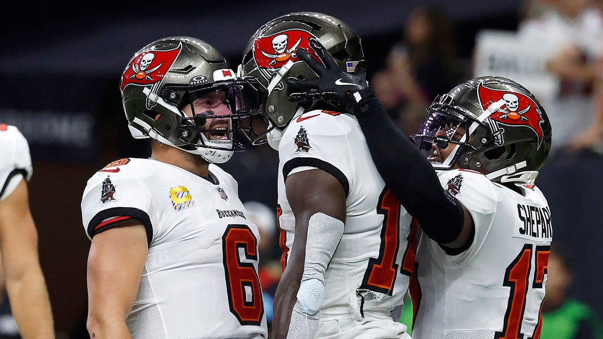 Baker Mayfield celebrating with Chris Godwin and Sterling Shepard