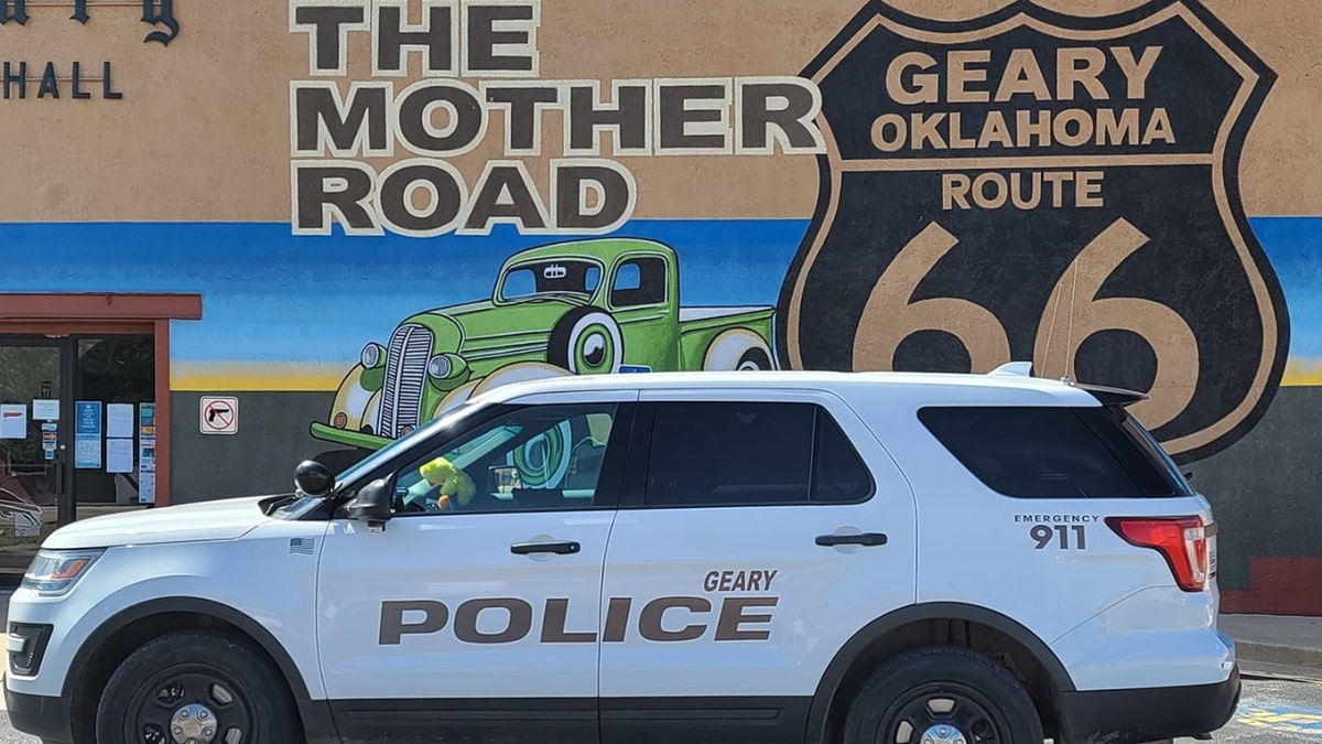 A Geary PD vehicle beneath a mural that says 