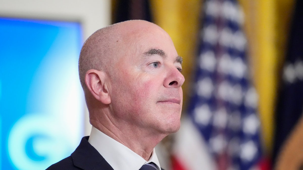 Homeland Security Secretary Alejandro Mayorkas listens as President Biden speaks about an executive order in the East Room at the White House in Washington, D.C., on Tuesday, June 4, 2024.