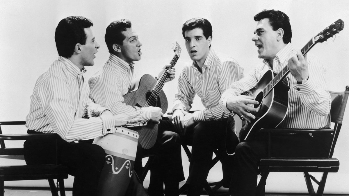 Frankie Valli and the Four Seasons sit in a circle