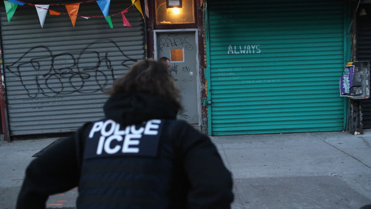 U.S. Immigration and Customs Enforcement officers look to arrest an undocumented immigrant during an operation in the Bushwick neighborhood of Brooklyn on April 11, 2018 in New York City.