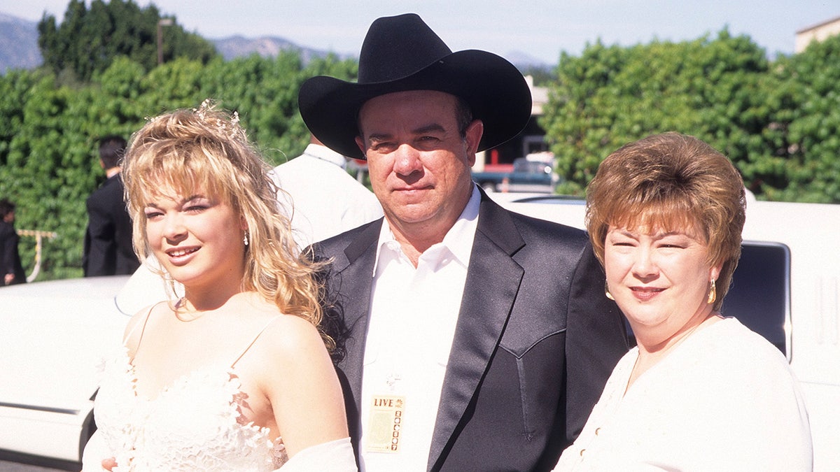 LeAnn Rimes, Wilbur Rimes and Belinda Rimes posing together in 1997