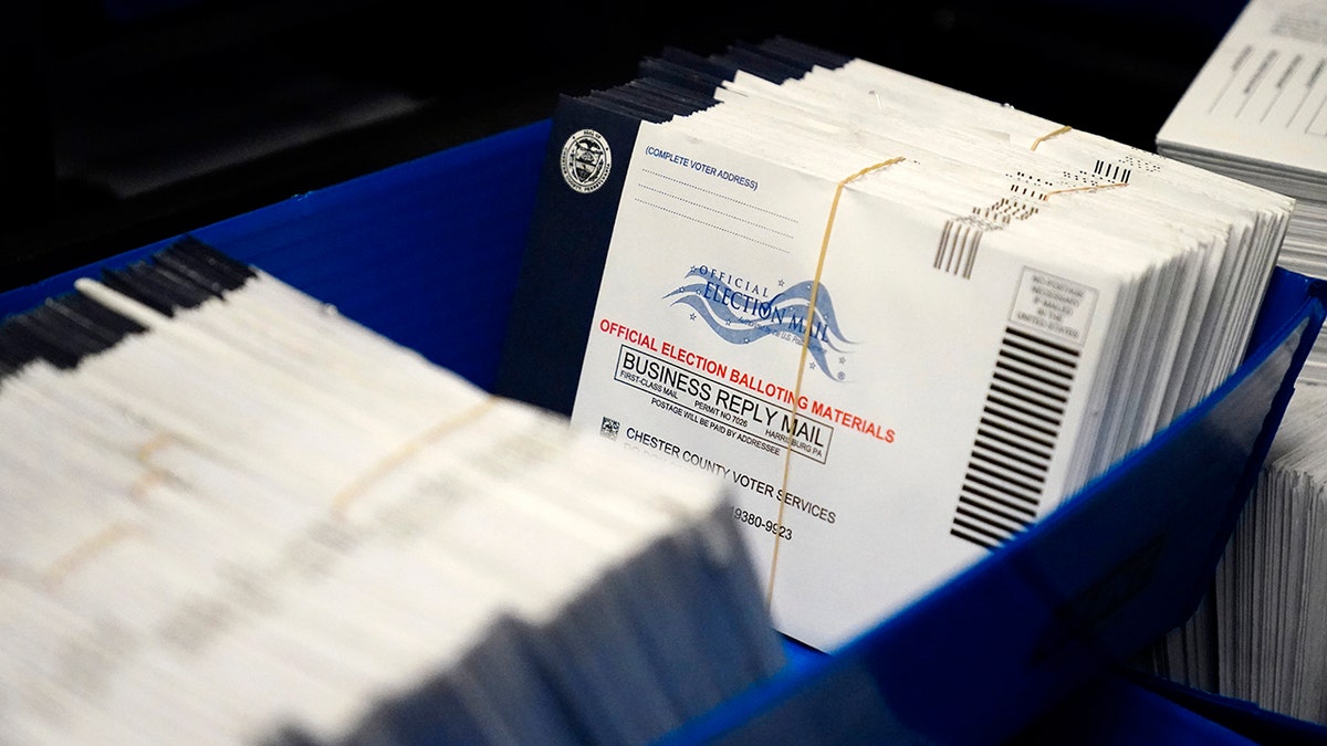 tray full of mail-in ballots