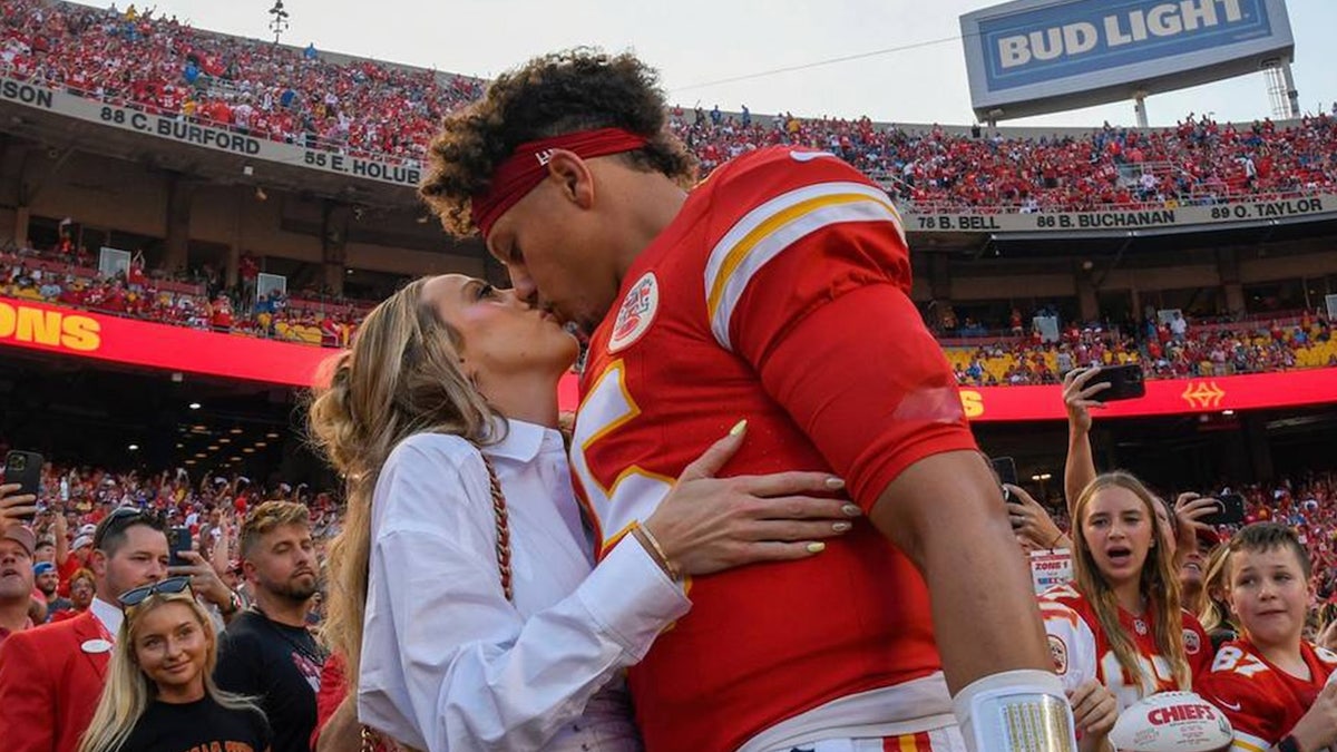 Chiefs quarterback Patrick Mahomes kisses his wife, Brittany Mahomes, before kickoff against the Detroit Lions on Sept. 7 at GEHA Field at Arrowhead Stadium.