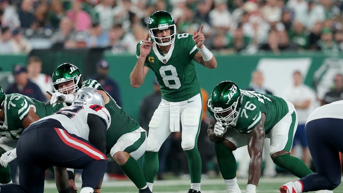 New York Jets QB Aaron Rodgers makes a presnap adjustment against the New England Patriots at MetLife Stadium. (Brad Penner-Imagn Images)