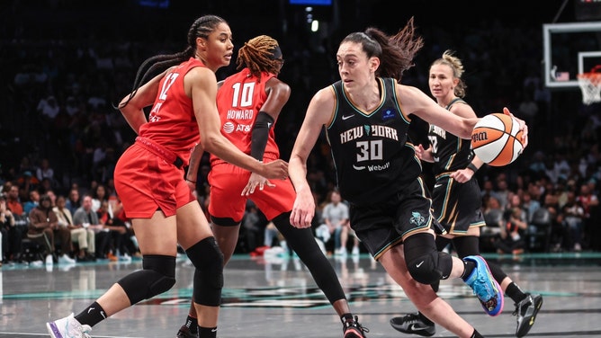 New York Liberty forward Breanna Stewart drives past Atlanta Dream forward Nia Coffey in Game 1 of the first round in the 2024 WNBA Playoffs at Barclays Center. (Wendell Cruz-Imagn Images)