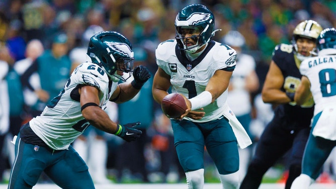 Philadelphia Eagles QB Jalen Hurts hands off to RB Saquon Barkley against the New Orleans Saints at Caesars Superdome. (Stephen Lew-Imagn Images)