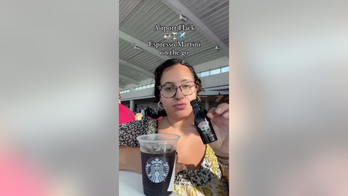 woman adds Bailey's to airport coffee