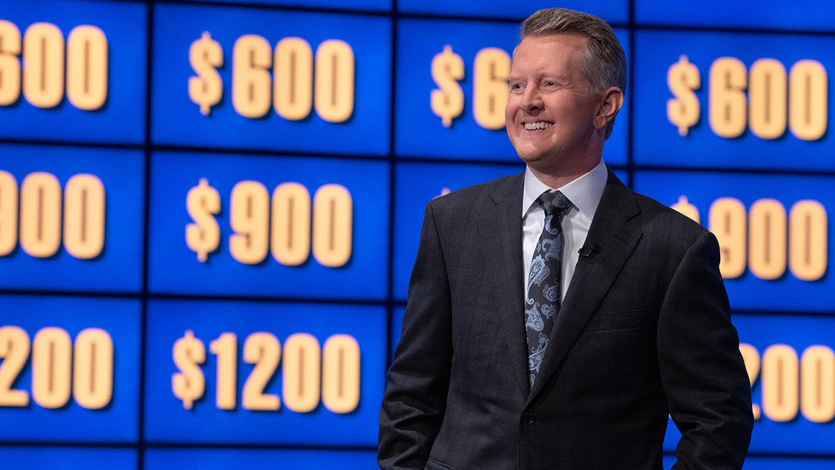 Ken Jennings standing in front of a 