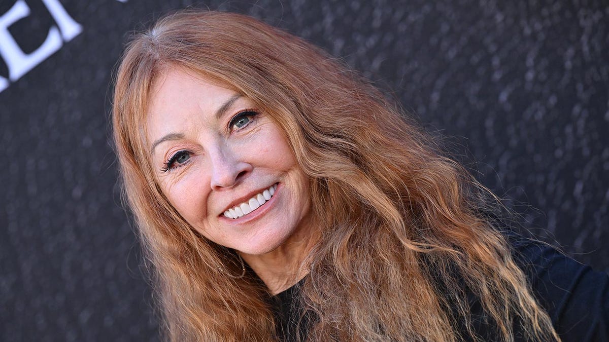 Cassandra Peterson as herself smiling on the carpet