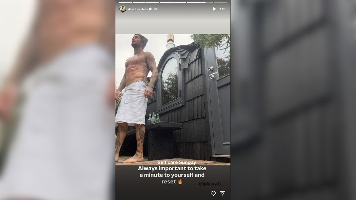 David Beckham flashes his abs in a shirtless selfie.