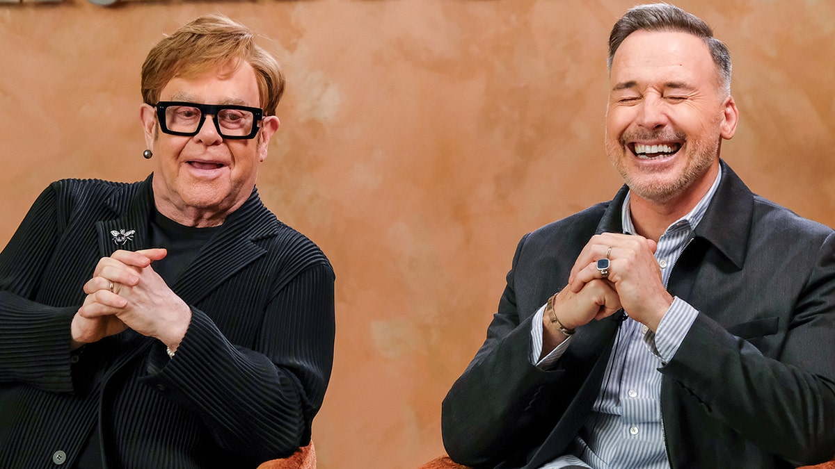 Elton John and David Furnish laugh together