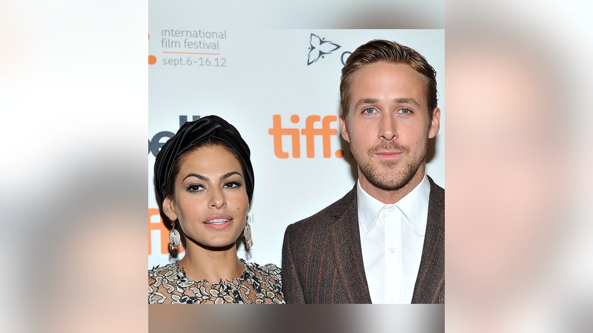 Eva Mendes and Ryan Gosling pose on the carpet together in Canada