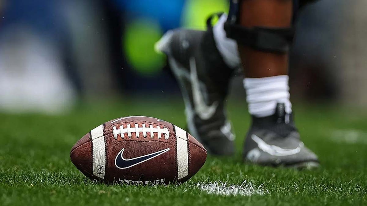 A football sits on turf