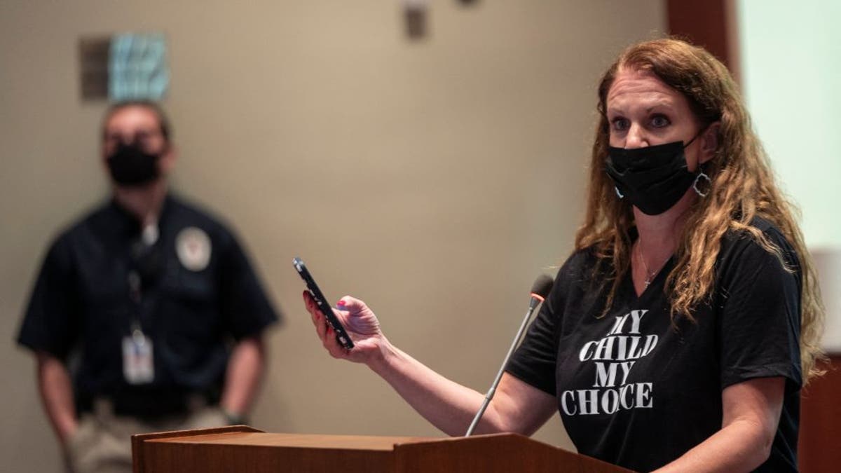 parent testifying at school board in 2021 wearing mask