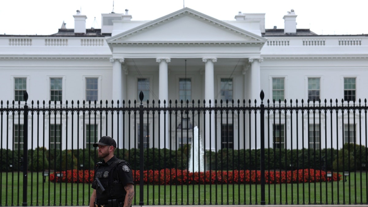 A uniformed Secret Service agent stands guard after U.S. President Joe Biden announced he dropped out of the race for re-election, outside of the White House on July 21, 2024 in Washington, DC.