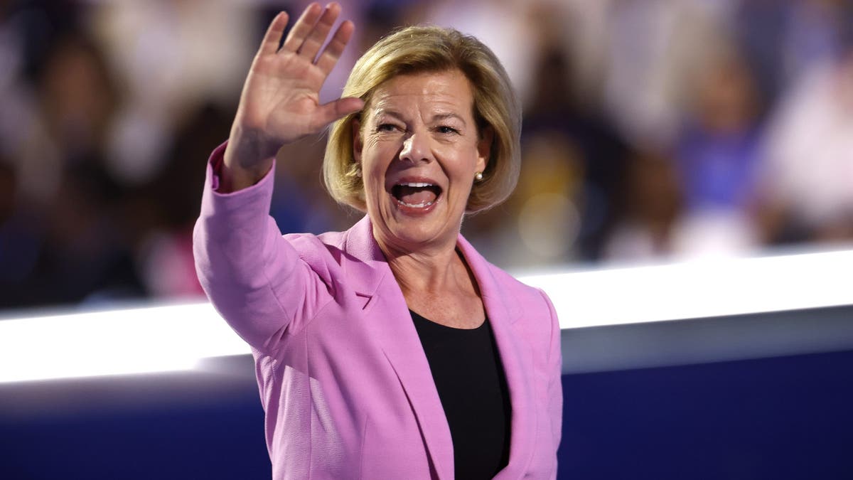 Sen. Tammy Baldwin waves after speaking onstage during the Democratic National Convention on Aug. 22, 2024 in Chicago. (Kevin Dietsch/Getty Images)