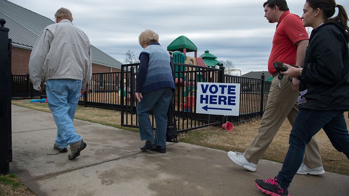 Voters arrive to cast their ballots at Grace United Methodist Church on March 1, 2016, in Conway, Arkansas.