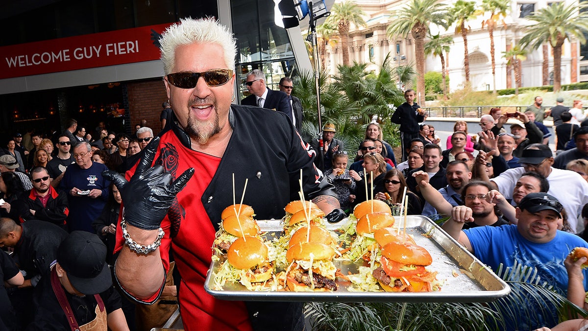 Guy Fieri serving burgers