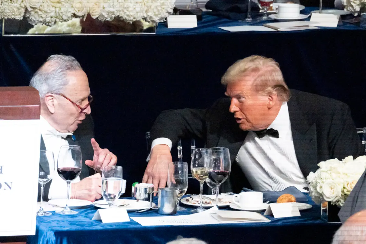 Former President Donald Trump (R) and Sen. Chuck Schumer (L) chat at the 79th Annual Alfred E. Smith Memorial Foundation Dinner at the New York Hilton Midtown, on Oct. 17, 2024. (Samira Bouaou/The Epoch Times)