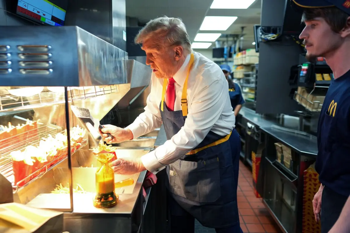 Former President Donald Trump works behind the counter making french fries during a visit to a McDonald's restaurant in Feasterville-Trevose, Pa., on Oct. 20, 2024. (Doug Mills-Pool/Getty Images)