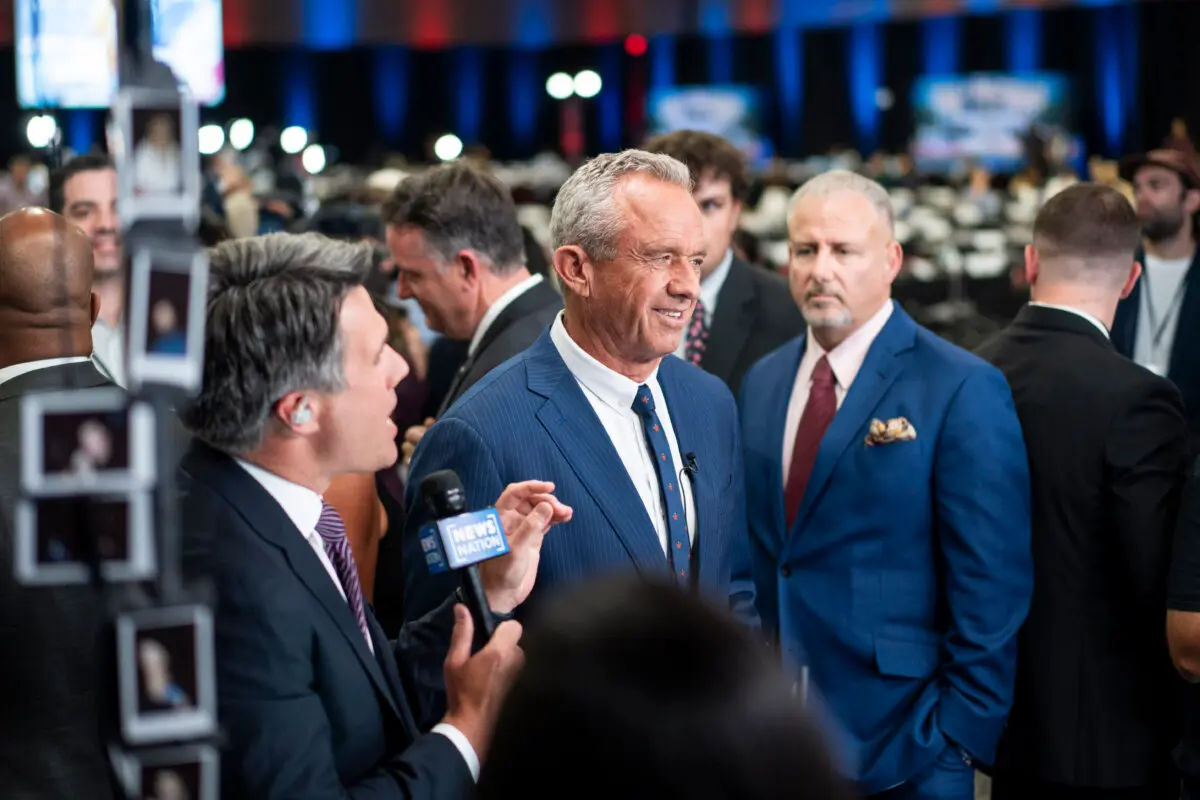 Robert F. Kennedy Jr. (C) speaks to reporters in the spin room at the Pennsylvania Convention Center ahead of the presidential debate between former President Donald Trump and Vice President Kamala Harris in Philadelphia, Pa., on Sept. 10, 2024. (Madalina Vasiliu/The Epoch Times)