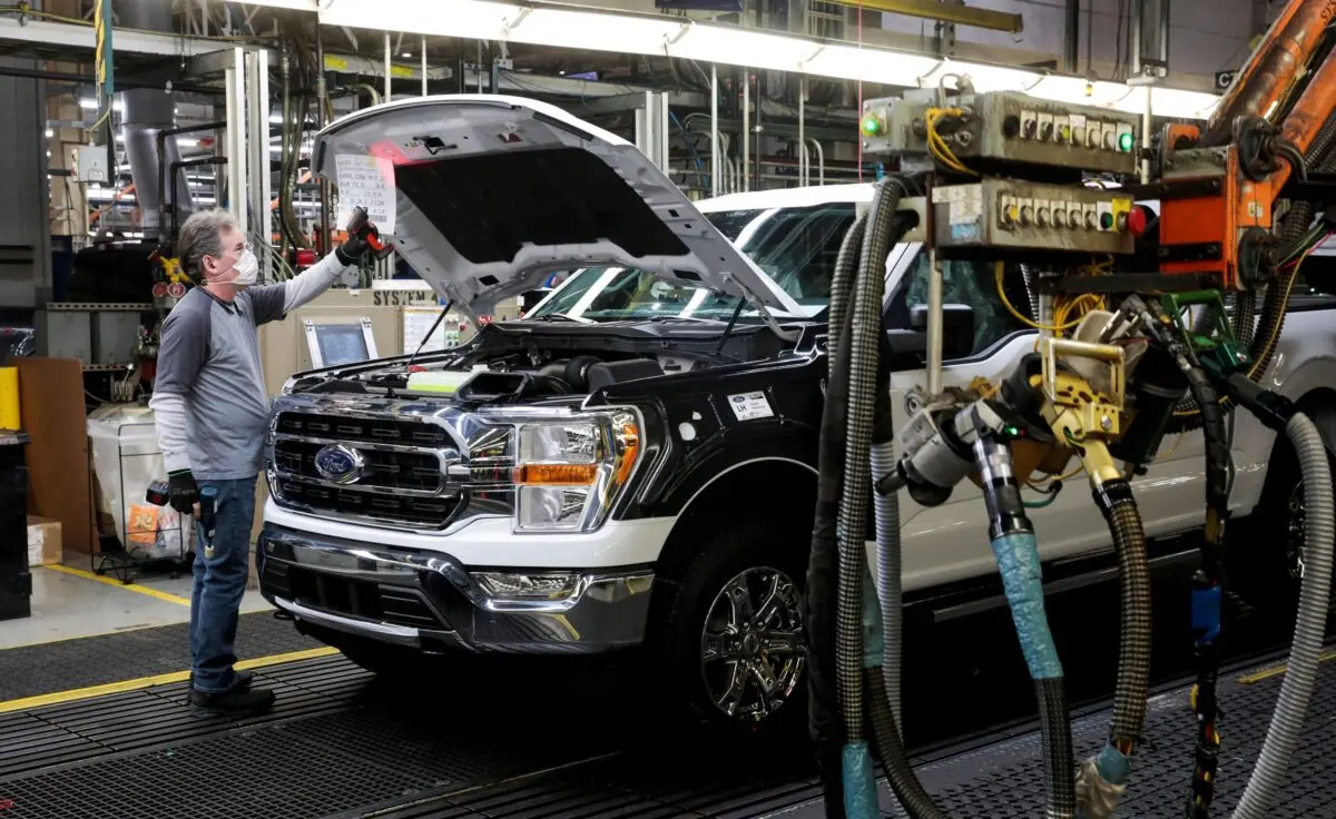 An assembly worker of Ford Motor works on an F-series pickup truck at the Dearborn Truck Plant in Dearborn, Mich., on Jan. 26, 2022. (Rebecca Cook/Reuters)