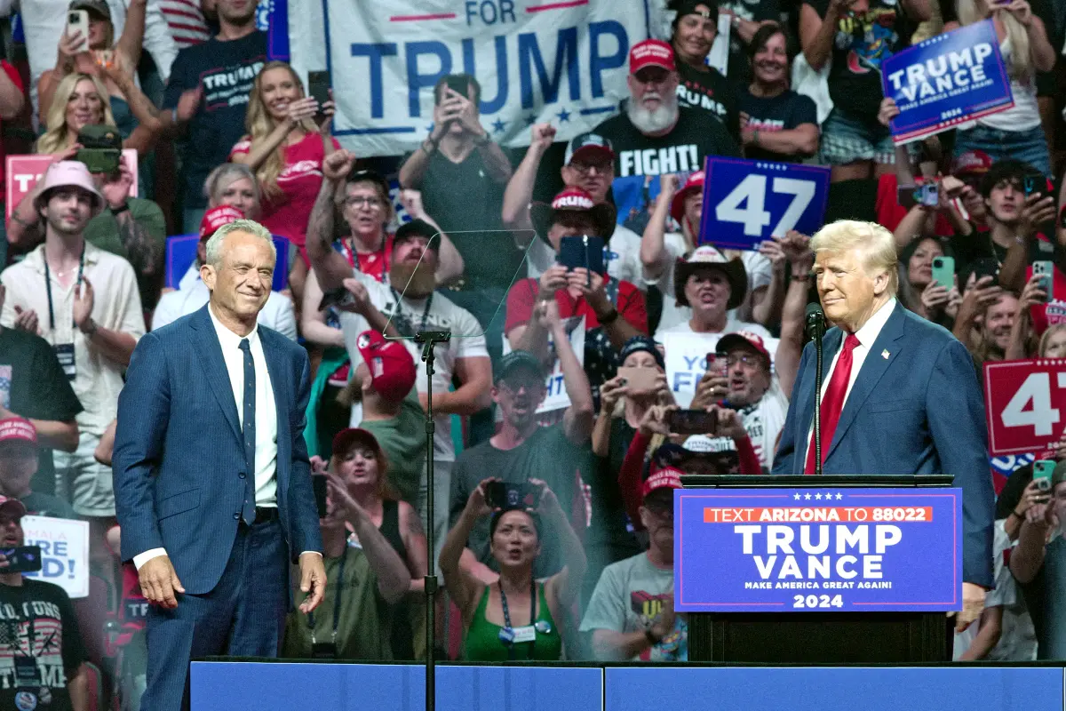 Former President Donald Trump (R) welcomes onstage Robert F. Kennedy Jr. (L) during a campaign rally in Glendale, Ariz., on Aug. 23, 2024. (Olivier Touron/AFP via Getty Images)