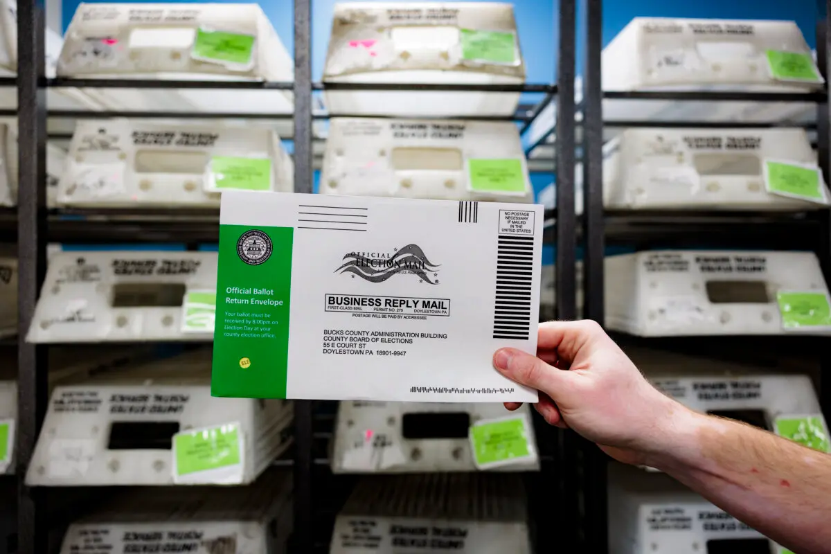 Director of the Board of Elections Tyler Burns holds a test ballot during a mail-in ballot processing demonstration at the Board of Elections office in Doylestown, Pa., on Sept. 30, 2024. (Hannah Beier/Getty Images)