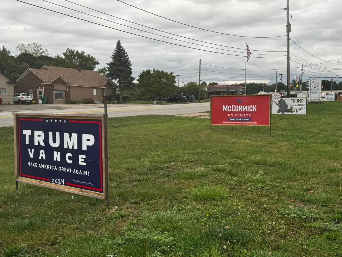 Signs along a major roadway show support for former President Donald Trump, Sen. JD Vance (R-Ohio), and Senate contender Dave McCormick in Erie County, Pa., on Sept. 30. (Joseph Lord/The Epoch Times)