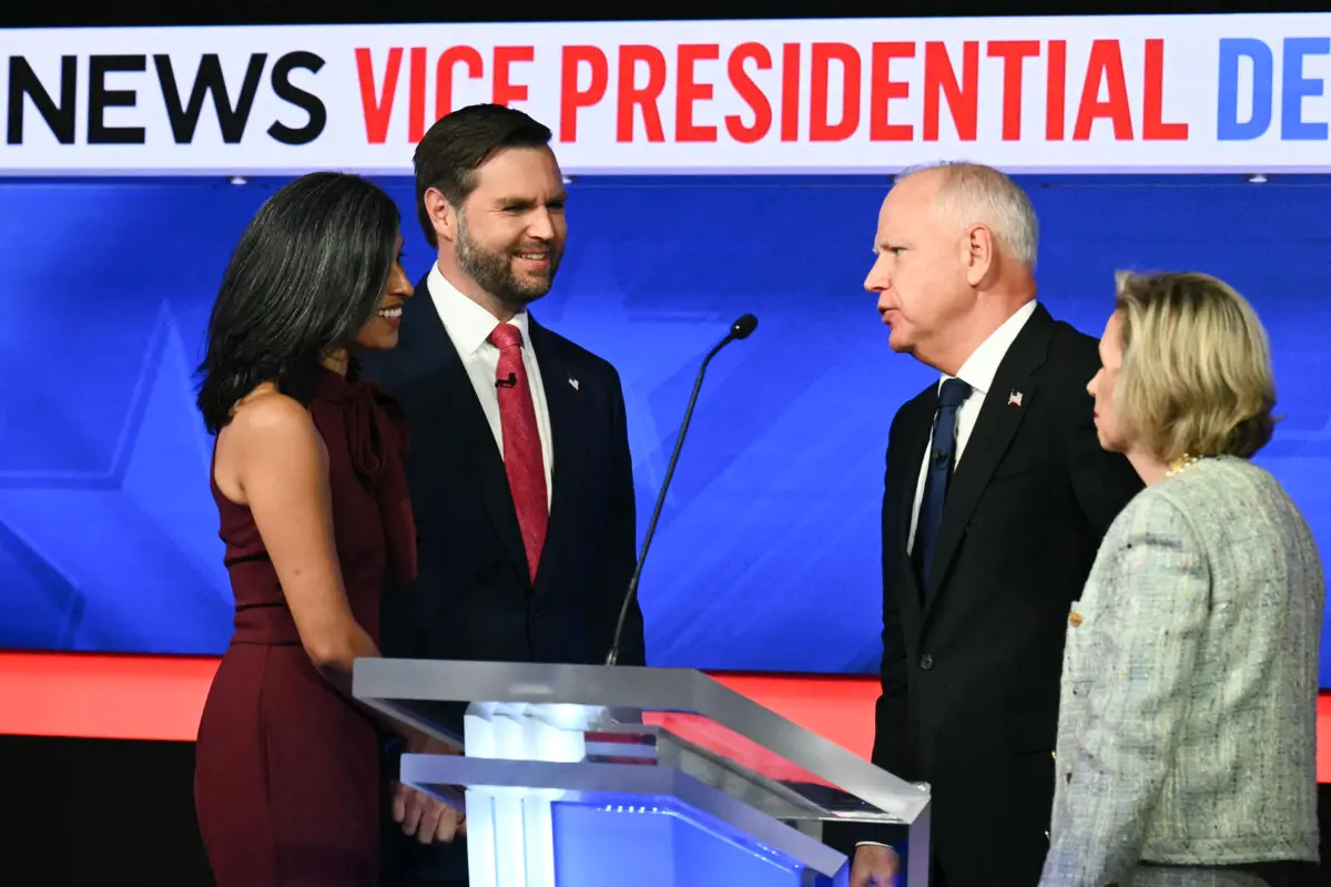 Sen. JD Vance (2nd L) and his wife Usha Vance (L) greet Minnesota Gov. Tim Walz (2nd R) and his wife Gwen Walz (R) at the end of the debate in New York, on Oct. 1, 2024. (Angela Weiss/AFP via Getty Images)