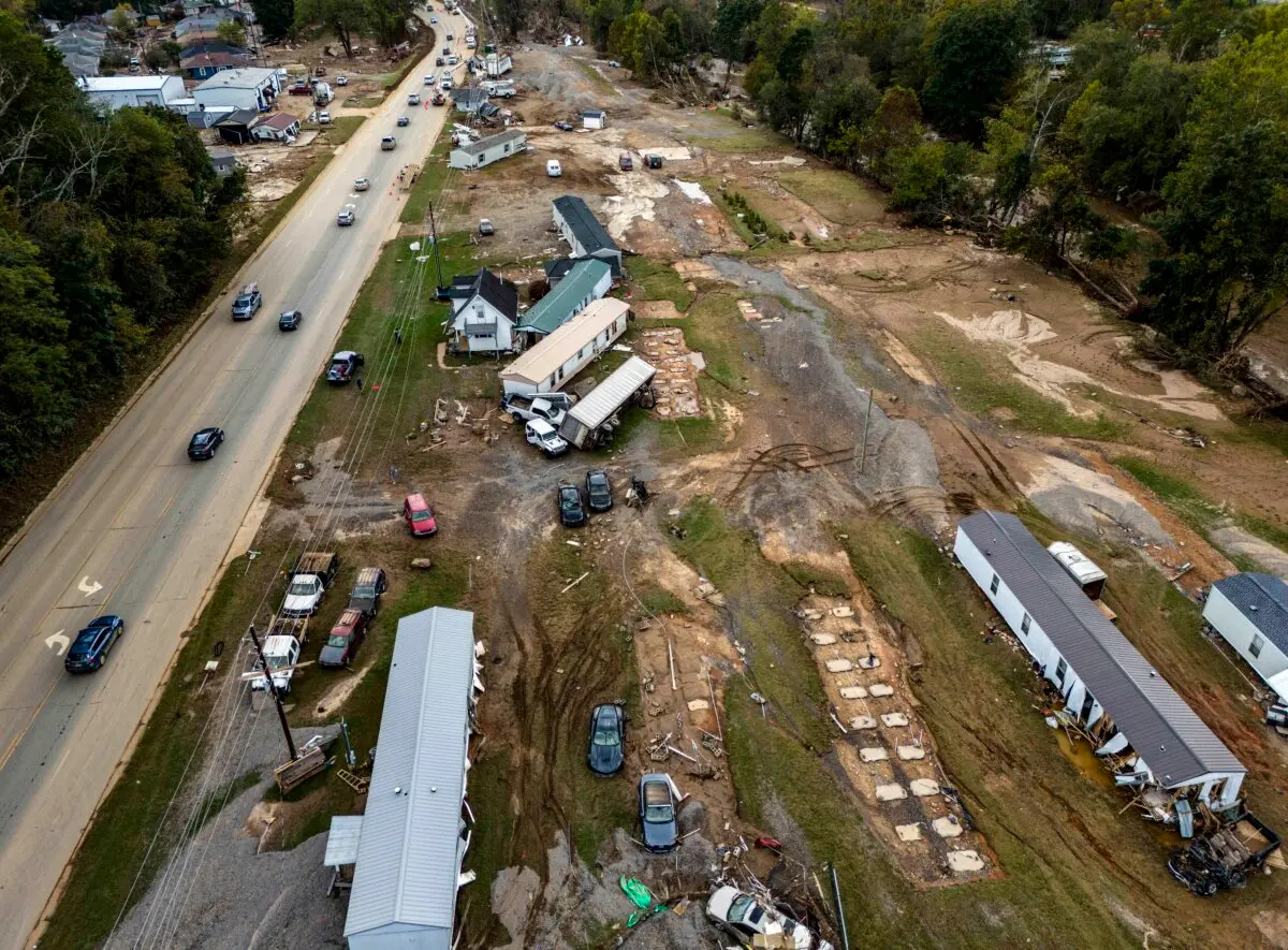 Homes and vehicles damaged in a flash flood from Hurricane Helene lie on the side of a road near the Swannanoa River in Swannanoa, N.C. Oct. 1, 2024. (Mike Stewart/AP Photo)