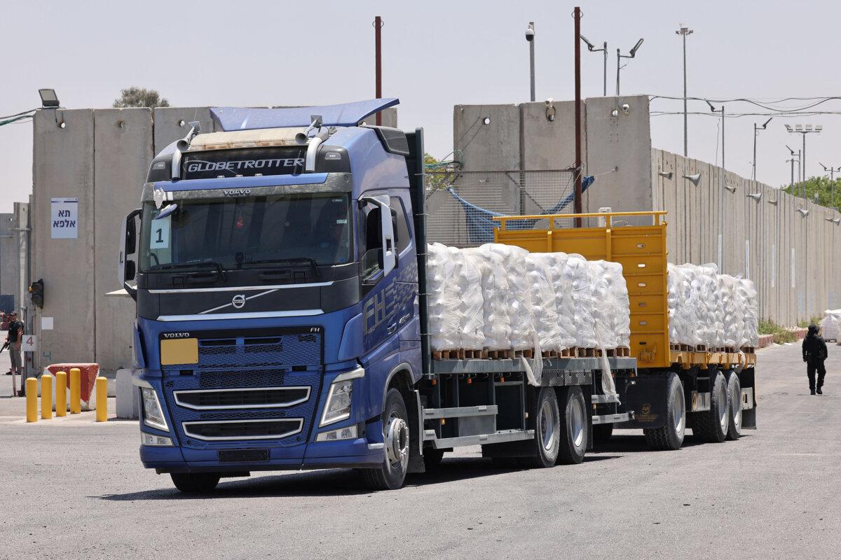 A truck carrying humanitarian aid for the Gaza Strip drives at the Kerem Shalom (Karm Abu Salem) border crossing between southern Israel and Gaza on May 30, 2024. (Jack Guez/AFP via Getty Images)