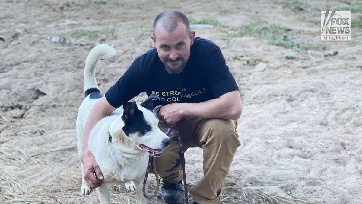 Kris Weil poses with his dog