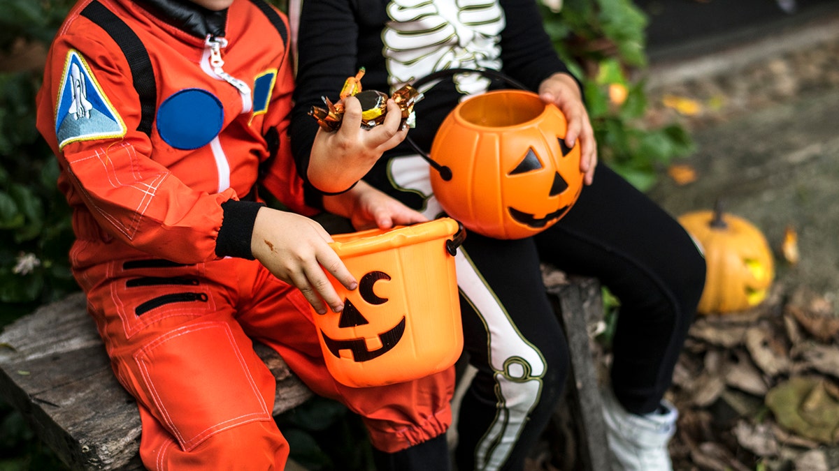 Little children trick or treating on Halloween