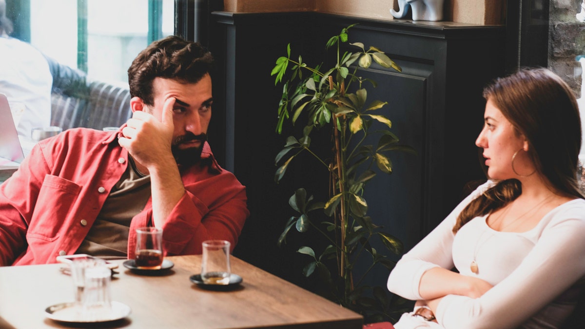 Couple arguing at a cafe