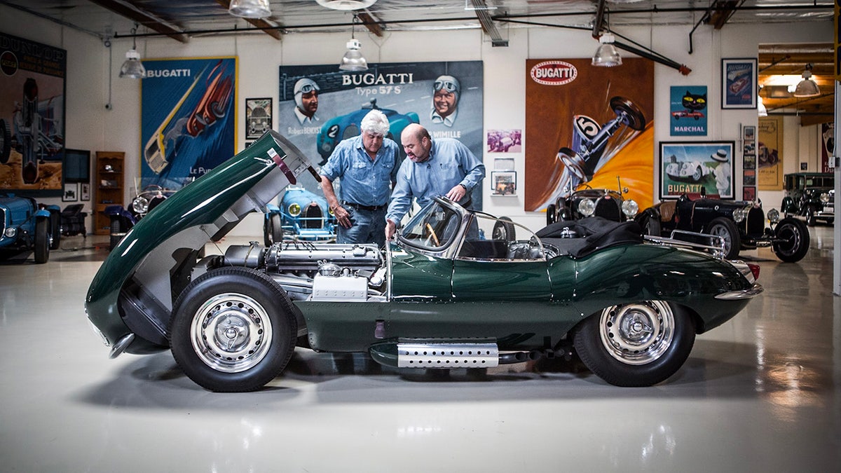 Jay Leno looking at a car with another person