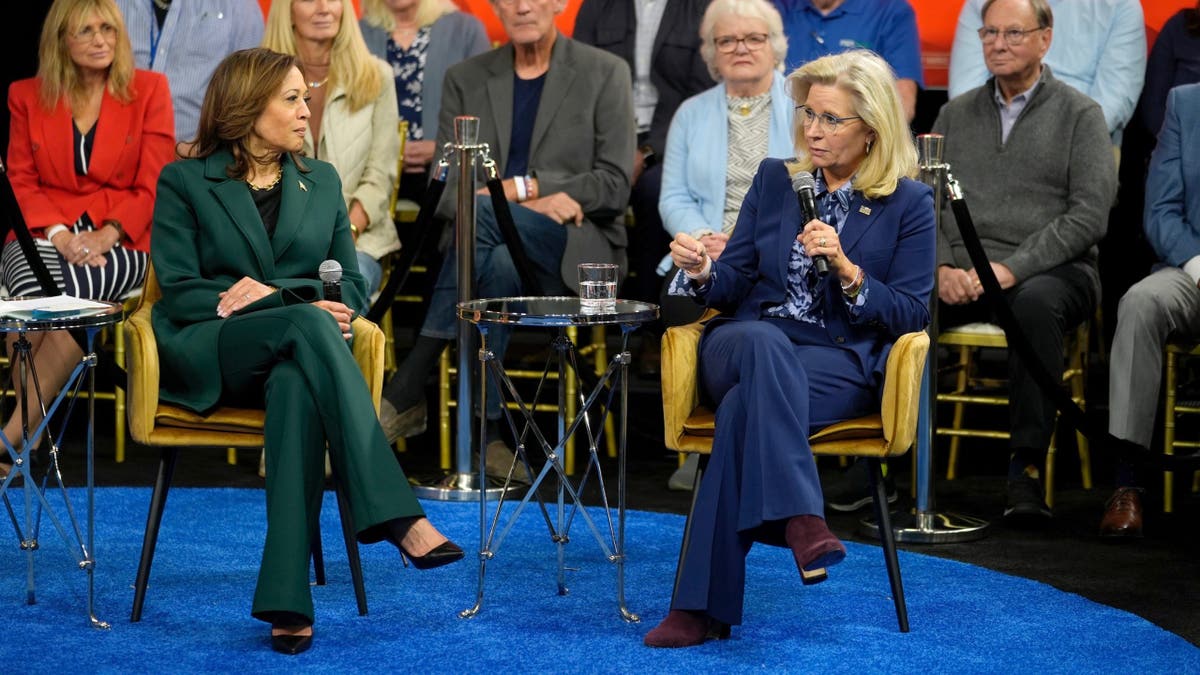 Democratic presidential nominee Vice President Kamala Harris listens as Former Republican Congresswoman Liz Cheney speaks during a town hall at The People's Light in Malvern, Pa., Monday, Oct. 21, 2024. (AP Photo/Matt Rourke)