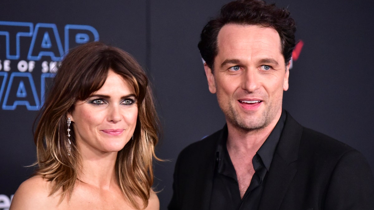 Keri Russell and Matthew Rhys walk a red carpet