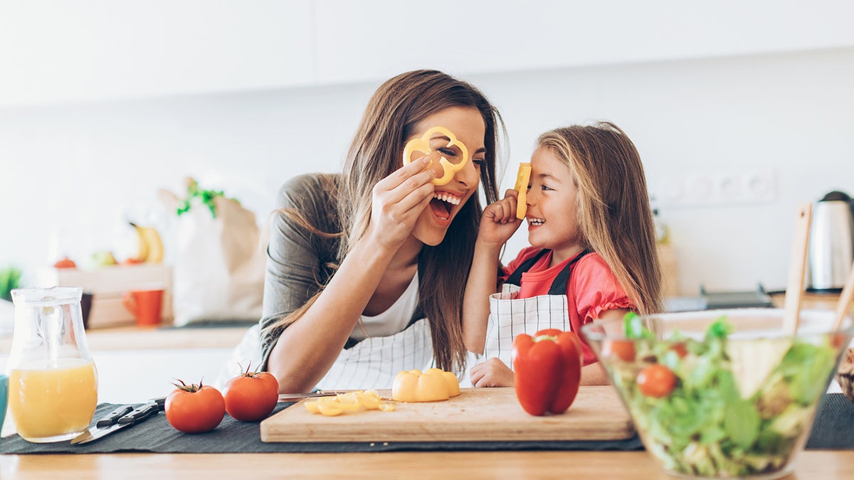 Kid and mom cooking in the kitchen