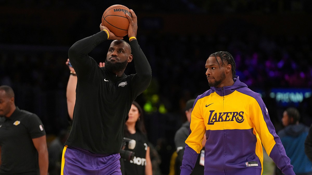 LeBron and Bronny James warm up