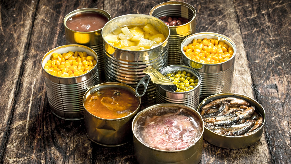 Canned foods are open on a table.